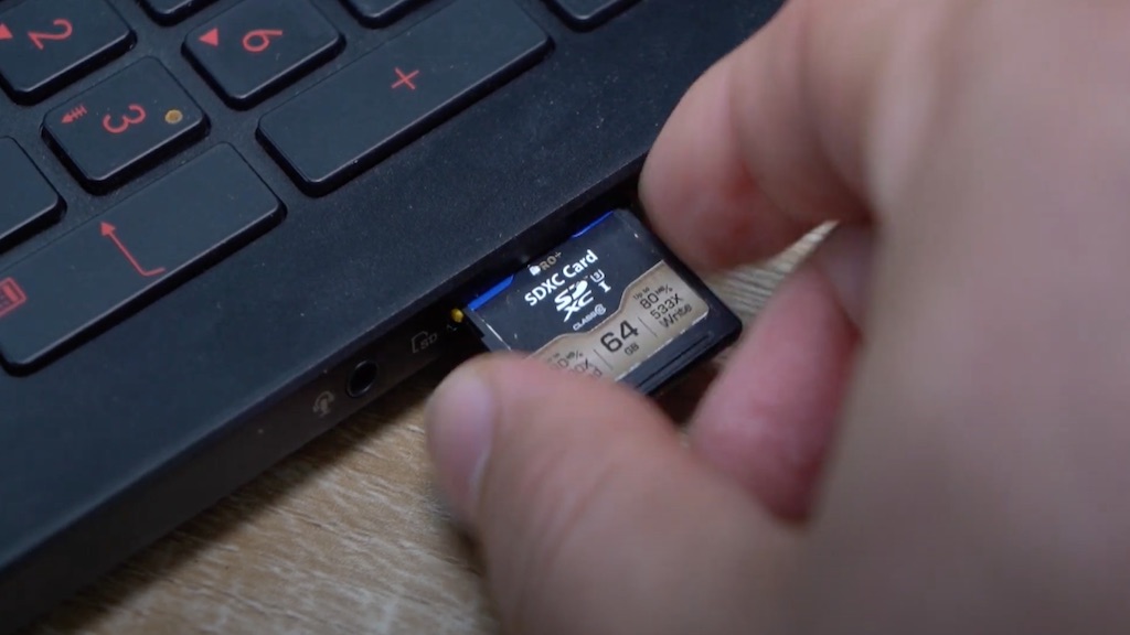 Insertion de carte SD dans le lecteur intégré d'un ordinateur portable.